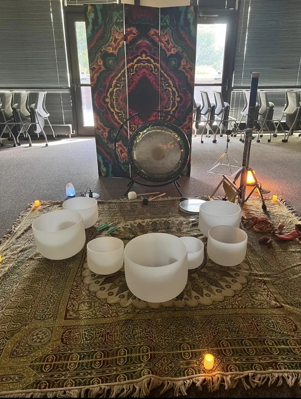 Accord Soundworks' real sound bath setup with crystal bowls, gong, chimes, and colorful backdrop